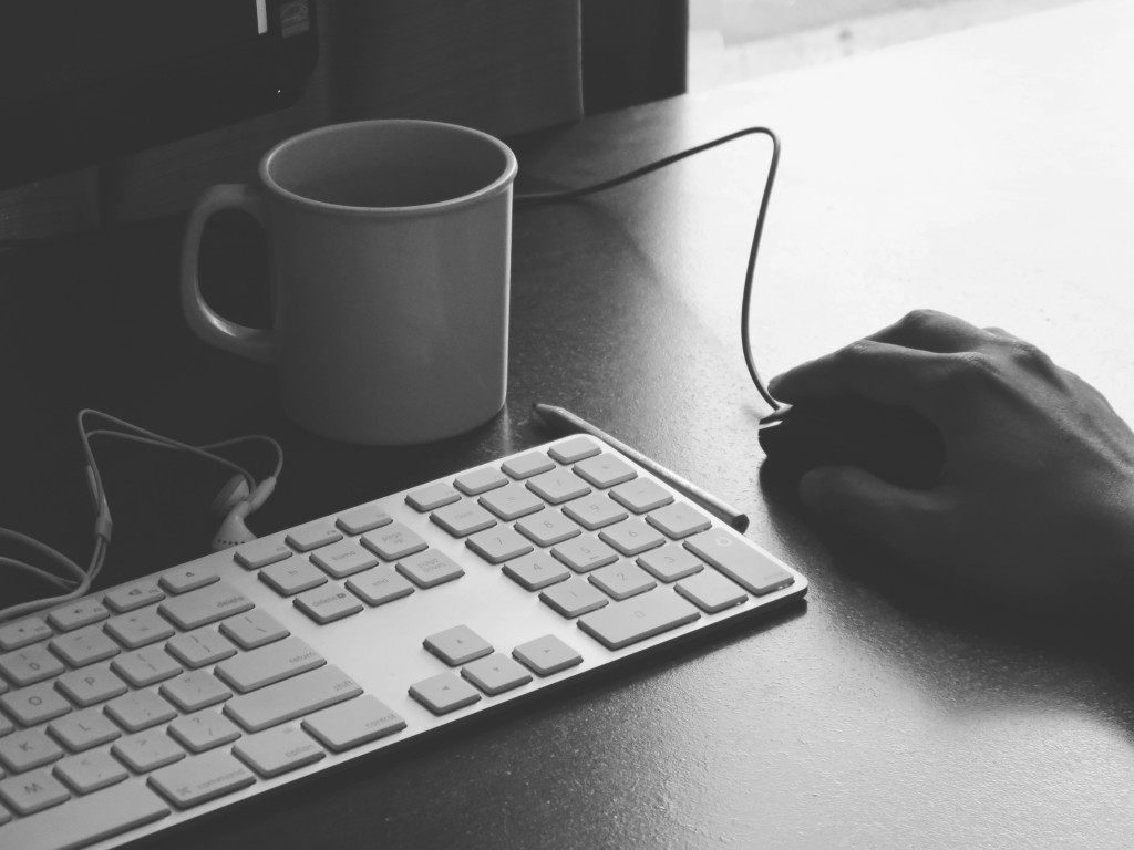 keyboard and mouse with hand on it to symbolize video editing